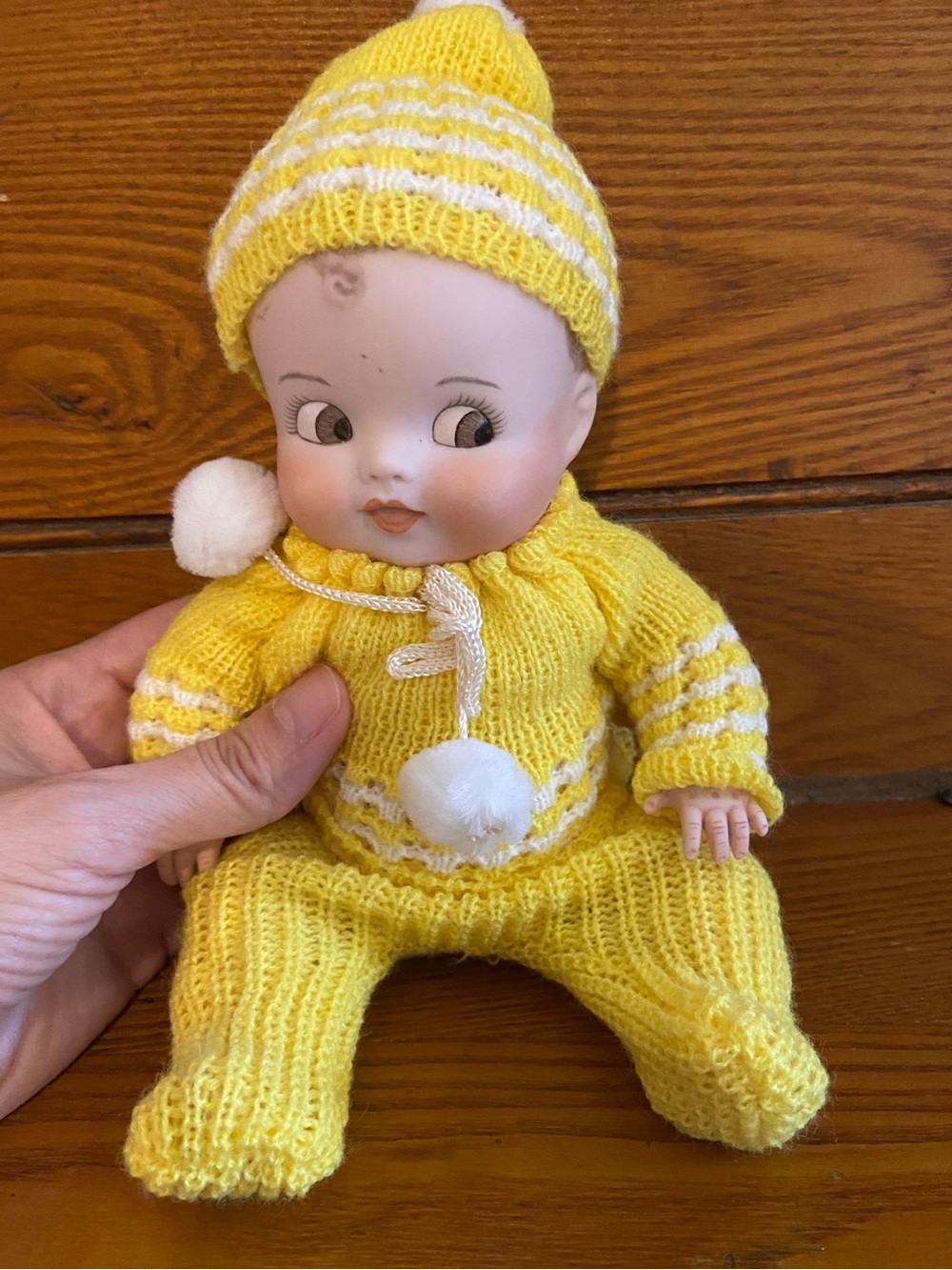 Antique reproduction porcelain doll in yellow Knit Pom-Pom Outfit